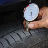 cars tyre being measured
